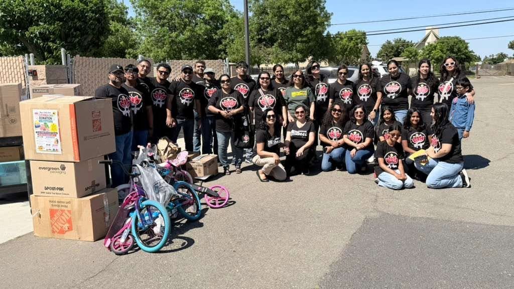 Team Aadya volunteers with donated boxes, bicycles, and toys